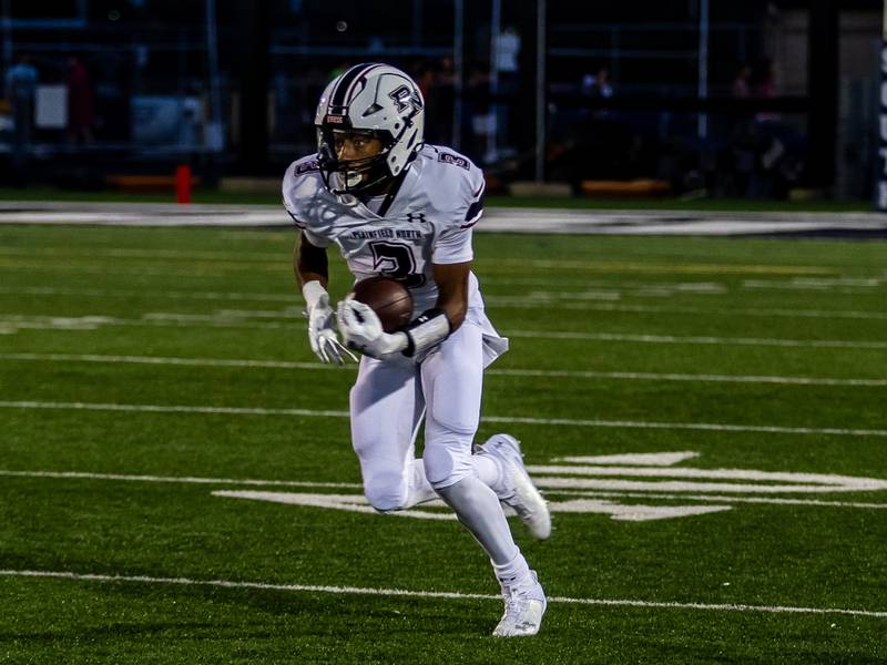 Plainfield North's Darin Ashiru runs downfield against Plainfield South on Sept. 13, 2024.