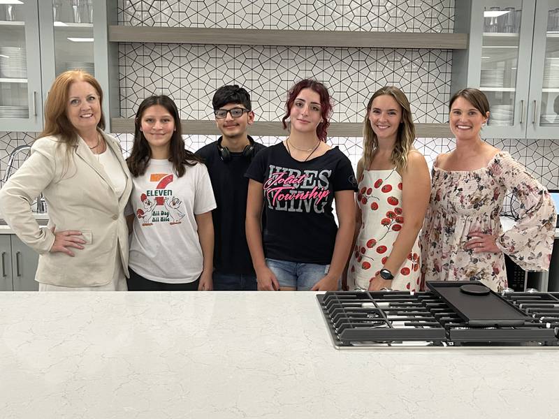 Joliet West High School teacher Michelle O'Malley (from left), students Seianna Lozano, Isac Lozano, Vanessa O'Connor and Jasmine Rosenboom and Joliet West culinary instructor Ryann Hager pose in the new cooking classrooms at Joliet West High School on Friday, Aug. 15, 2025.