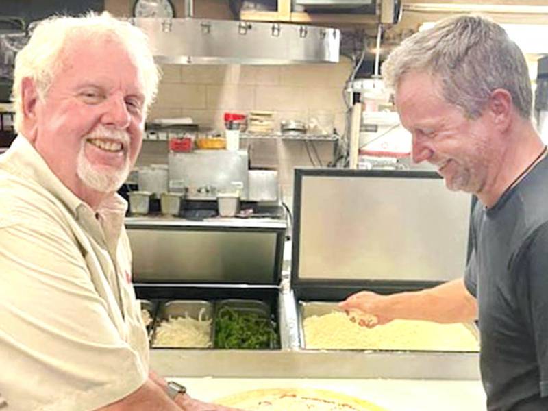 Larry Finn, co-owner of Pizza Villa in DeKalb, died unexpectedly at age 76 on Tuesday, Dec. 14, 2021. Finn is shown here (left) making a pizza at Pizza Villa with his son, Joe Finn (right) on Father's Day 2021. (Photo provided by CJ Finn)