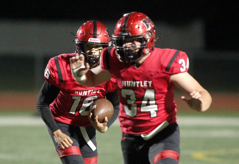 Huntley’s Braylon Bower runs the ball as Haiden Janke blocks against Niles West in first-round Class 8A playoff football action at Huntley Friday.