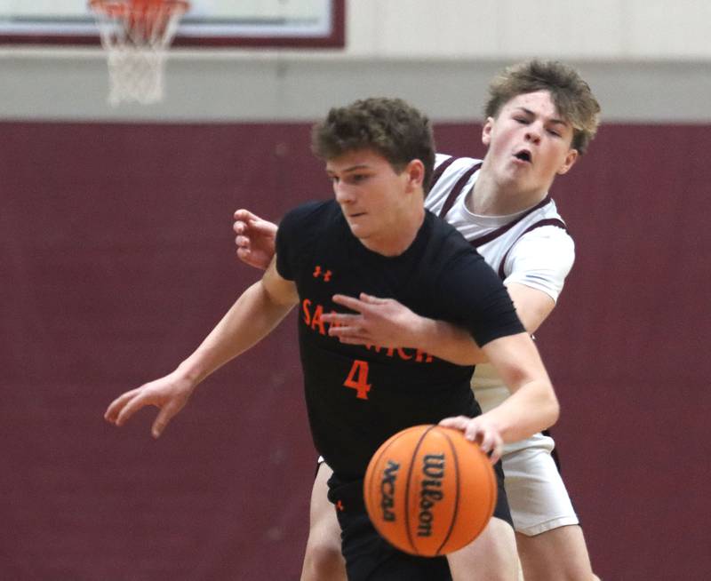 Marengo’s Blake Ritter, right, reaches for the ball as Sandwich’s  Griffin Somlock races downcourt in varsity boys basketball action on Saturday, Jan..24, 2025, at Marengo High School in Marengo.