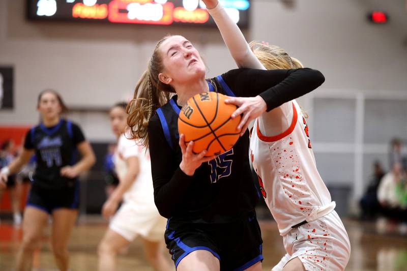 St. Charles North's Bronwyn How attemps a shot from under the basket during a game on Friday, Jan. 31, 2025 at St. Charles East.