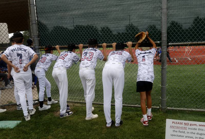 Members of the Cangelosi Sparks-McCotter teams watch the list inning of the game between Beisebol and the Northwest Outlaws during the opening round of the Under 13 McHenry County Youth Sports Association’s Summer International Championship baseball tournament on Friday, July 11, 2025, at the Mickey Sund Baseball Complex in Crystal Lake's Lippold Park.