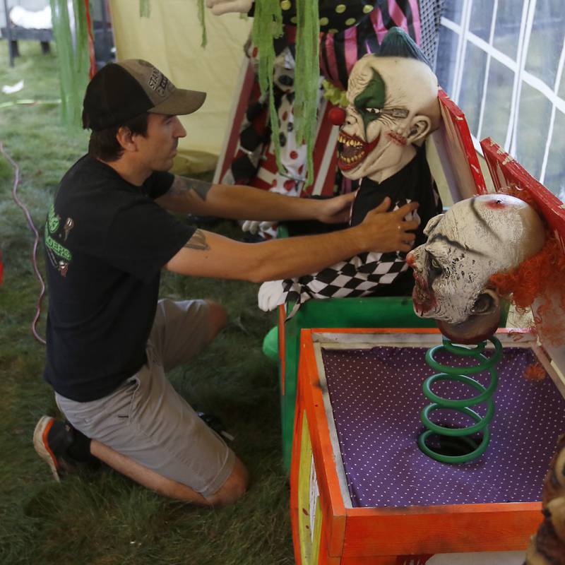 Chris Skaja works on setting up the "Massacre on McKinley" Halloween display at his home, 4 McKinley St. in Lake in the Hills, on Wednesday, Oct. 5, 2022. The display opens to the public on Saturday.
