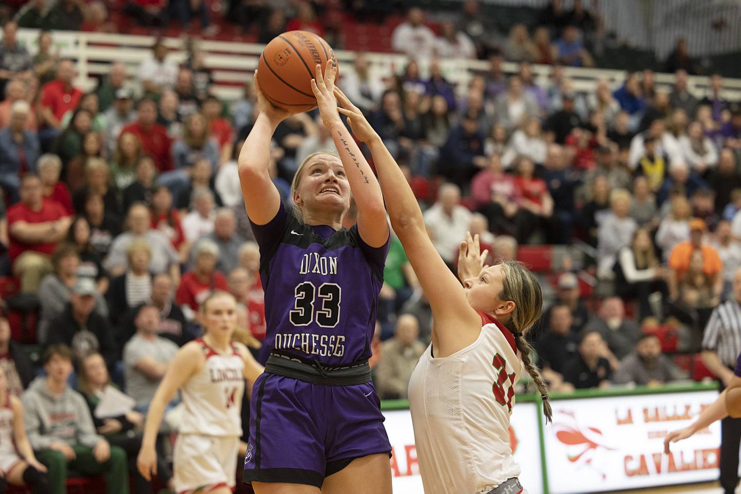 Dixon’s Jessie Pitman puts up a shot over Lincoln’s Makinley Knapp in the class 3A super sectional Monday, Feb. 26, 2024 at LaSalle-Peru High School.