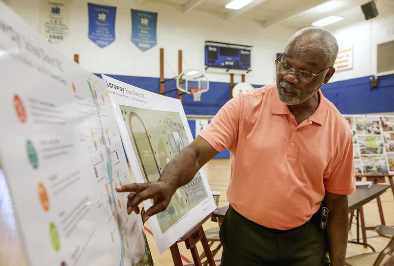 Saul Brass, vice president of the Laraway school board, points to several maps and graphs about the future site of the proposed new school building Wednesday in Joliet.