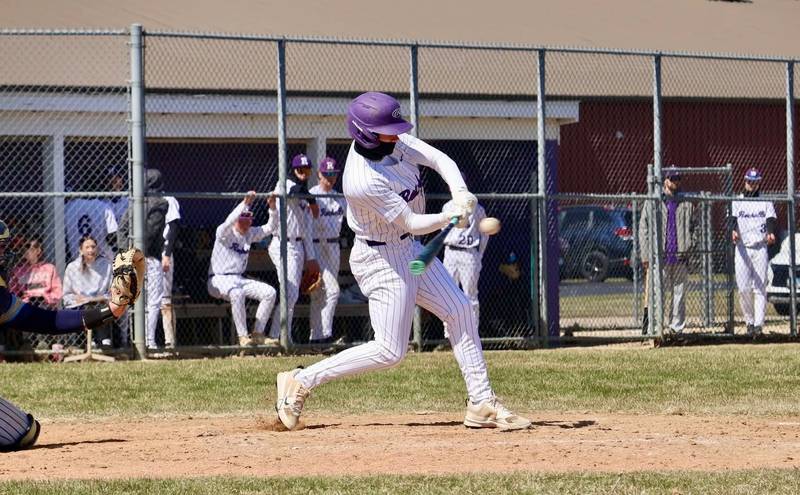 Rochelle's Van Gerber follows through on a hit during the Hubs' game with Ottawa Marquette.