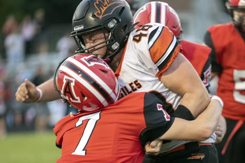 Milledgeville’s Karter Livengood is hit by Amboy’s Tanner Welch Friday, August 29, 2025, in Amboy.