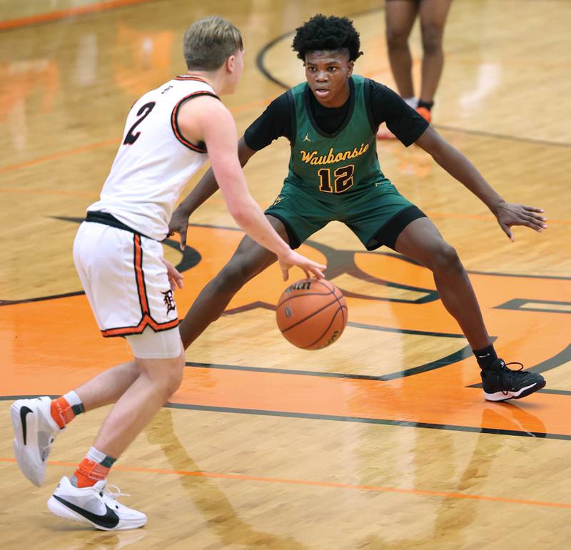 Waubonsie Valley's Tyreek Coleman plays defense against DeKalb’s Sean Reynolds during their game Friday, Dec. 15, 2023, at DeKalb High School.