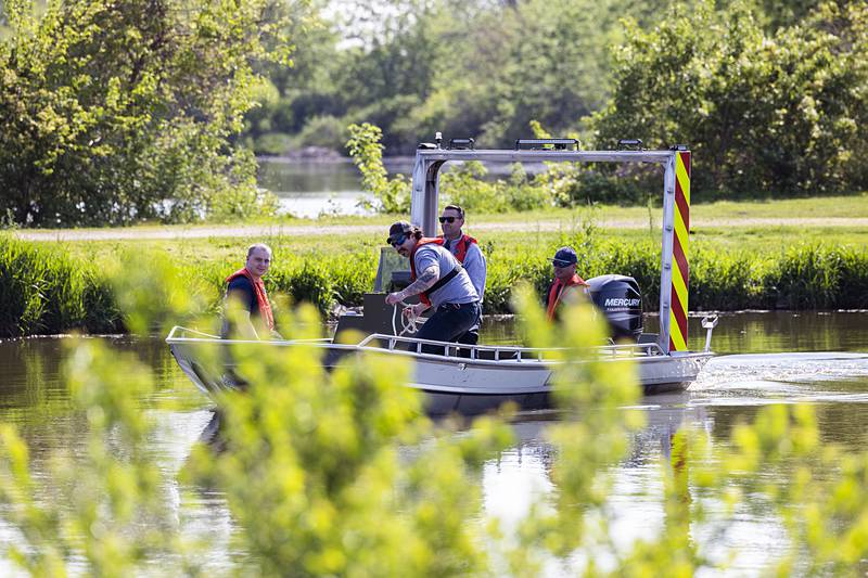 Rock Falls firefighters come in to pick up another load of buoys Wednesday, May 15, 2024 at the Oppold Marina in Sterling.