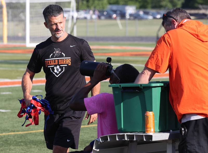 DeKalb assistant boys soccer coach Dave Lichamer (left) talks to head coach Patrick Hamilton Monday, July 14, 2025, before a summer boys soccer friendly against Sycamore at DeKalb High School.