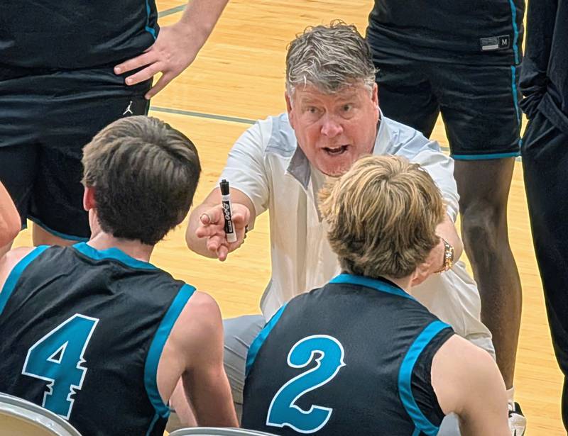 Woodstock North boys basketball coach Tim Paddock talks to his team during a timeout against Hononegah in the Hoops for Healing Classic on Wednesday, Nov. 26, 2025, at Woodstock North.