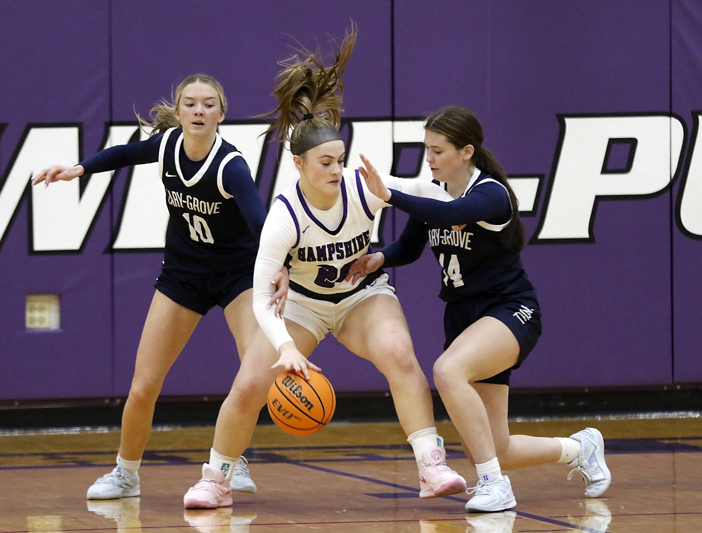 Cary-Grove's Alivia Nielsen (left) and Avery Stortz (right) double tam Hampshire's Chloe Van Horn during a Fox Valley Conference girls basketball game on Monday, Dec. 9, 2024, at Hampshire High School.
