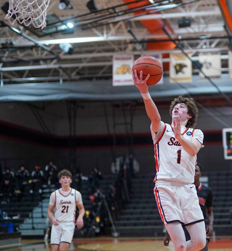 St. Charles East's Jake Greenspan (1) drives to the hoop on a fast break against East Aurora during the 64th annual Ron Johnson Thanksgiving Basketball Tournament at St. Charles East High School on Monday, Nov 20, 2023.