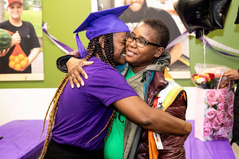 S.E.E.D. graduate Connie Jackson gives a hug to her mother, Melinda Harris, following the ceremony at the Northern Illinois Food Bank South Suburban Center in Joliet on March 14, 2024.