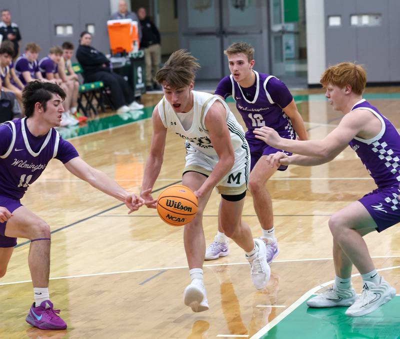 Bishop McNamara's Coen Demack is pressured by Wilmington players during Bishop McNamara's 61-24 victory over Wilmington in the IHSA Class 2A Seneca Sectional semifinal on Tuesday, March 3, 2026.