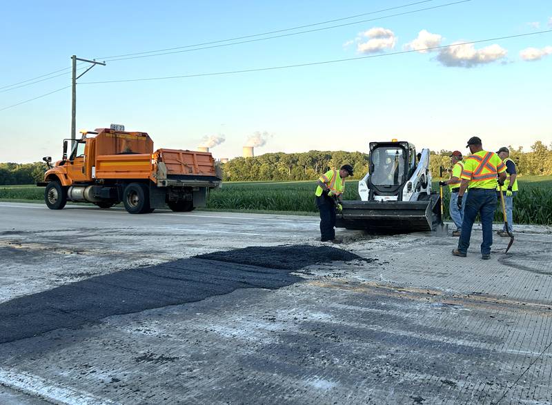 A crew from the Illinois Department of Transportation (IDOT) repairs one of two pavement blowouts on Illinois Route 2 Tuesday evening, July 1, 2025. The state highway was closed between Oregon and Byron as crews patched the roadway. This blowout was just north of Silver Ridge Golf Course.