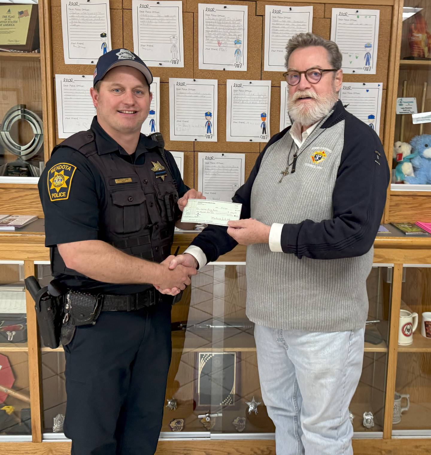 The Mendota Knights of Columbus passed along $1,000 to the Mendota Police Station for the Samaritan Fund. Pictured are Brian Corrigan with the Knights of Columbus and interim Police Chief Tyler Kent (left).