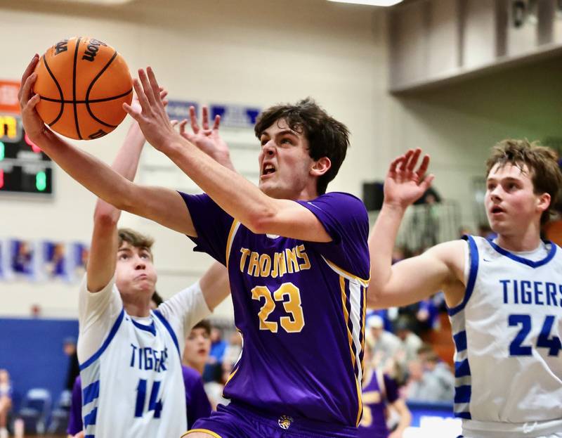Mendota's Dane Doyle shoots shoots between Princeton's Jackson Mason (14) and Ryan Jagers (24) Friday night at Prouty Gym.