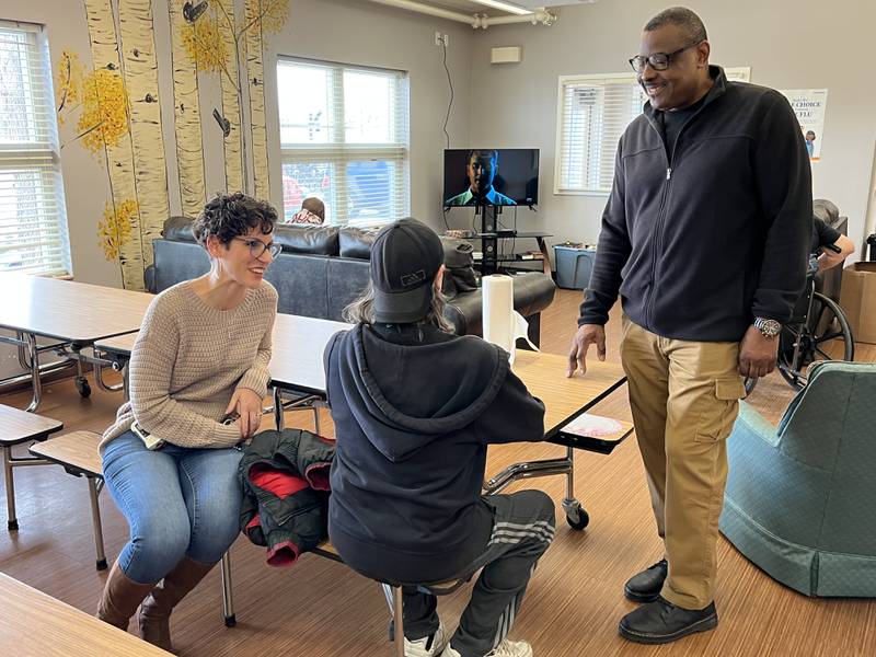 Angie Shoulis, Hope Haven's emergency shelter coordinator, and Gary Chapman, Hope Haven's Associate Director talk, in the men's common room, with an individual staying at the shelter on Jan. 6, 2023.