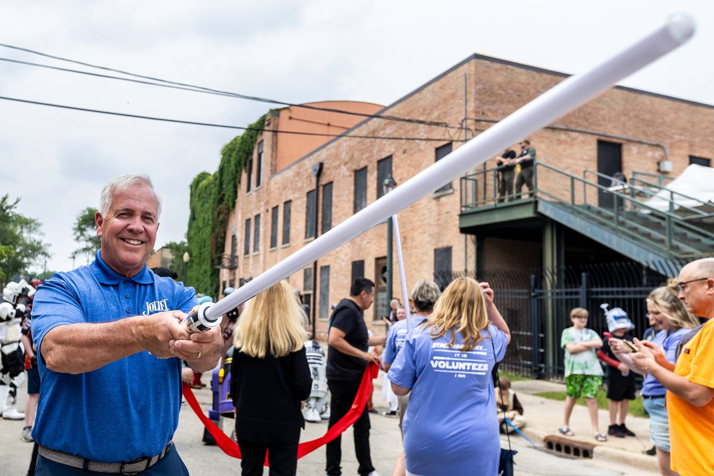 Joliet Mayor Terry D'Arcy wields a lightsaber during Joliet Public Library's Star Wars Day event on June 7, 2025.