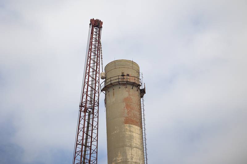 Steel reinforcement at the tip of St. Mary's Cement plant's stack is causing the demolition's progress to be slow and laborious.