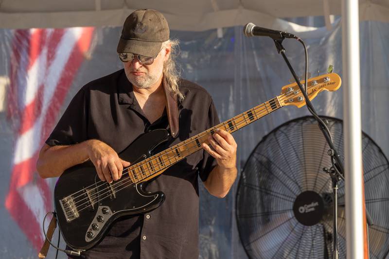 Jeff Cunningham of the Travis Reid Band "pops" strings of bass during performance at the BBQ & Blues Fest on Saturday, Sept. 12, 2025 on First Street in La Salle.