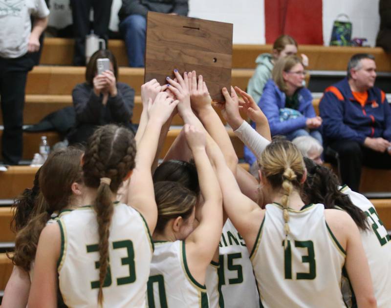 Members of the St. Bede Lady Bruin basketball team hoist the Tri-County Conference Tournament championship plaque after defeating Putnam County on Thursday, Jan. 18, 2024 at Henry-Senachwine High School.