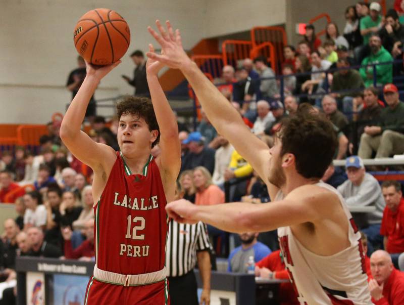 L-P's Michael Hartman shoots a jump shot over Metamora's Nick Walker during the Class 3A Sectional on Tuesday, Feb. 27, 2024 at Pontiac High School.