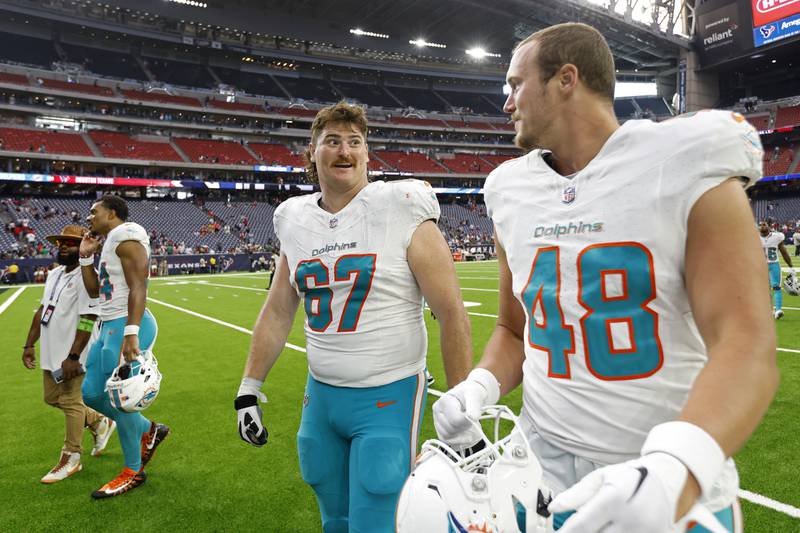 Guard Dan Feeney talks 
with teammate Tyler Kroft after a preseason game against the Houston Texans, Saturday, Aug. 19, 2023, in Houston.