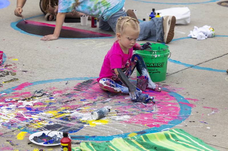 Channeling her inner Jackson Pollock, expressionist painter Kinsley Huizenga, 2, gets into her work during Morrison’s Paint the Town Saturday, Sept. 20, 2025.