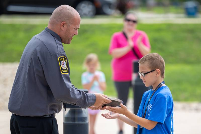 (left to right) Community Service Officer Blake Frund awards Jacob Rodriguez the Professional Development award at the first annual Juvenile Police Academy graduation ceremony on Friday, July 25, 2025 at the Peru Police Department in Peru.