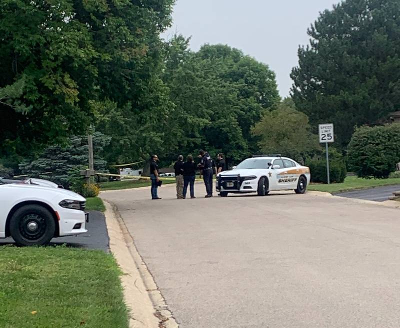 Law enforcement gather Wednesday, Aug. 9, 2023, on Wild Plum Road near Crystal Lake where the McHenry County Sheriff's Office said four people were shot and it was conducting a death investigation.