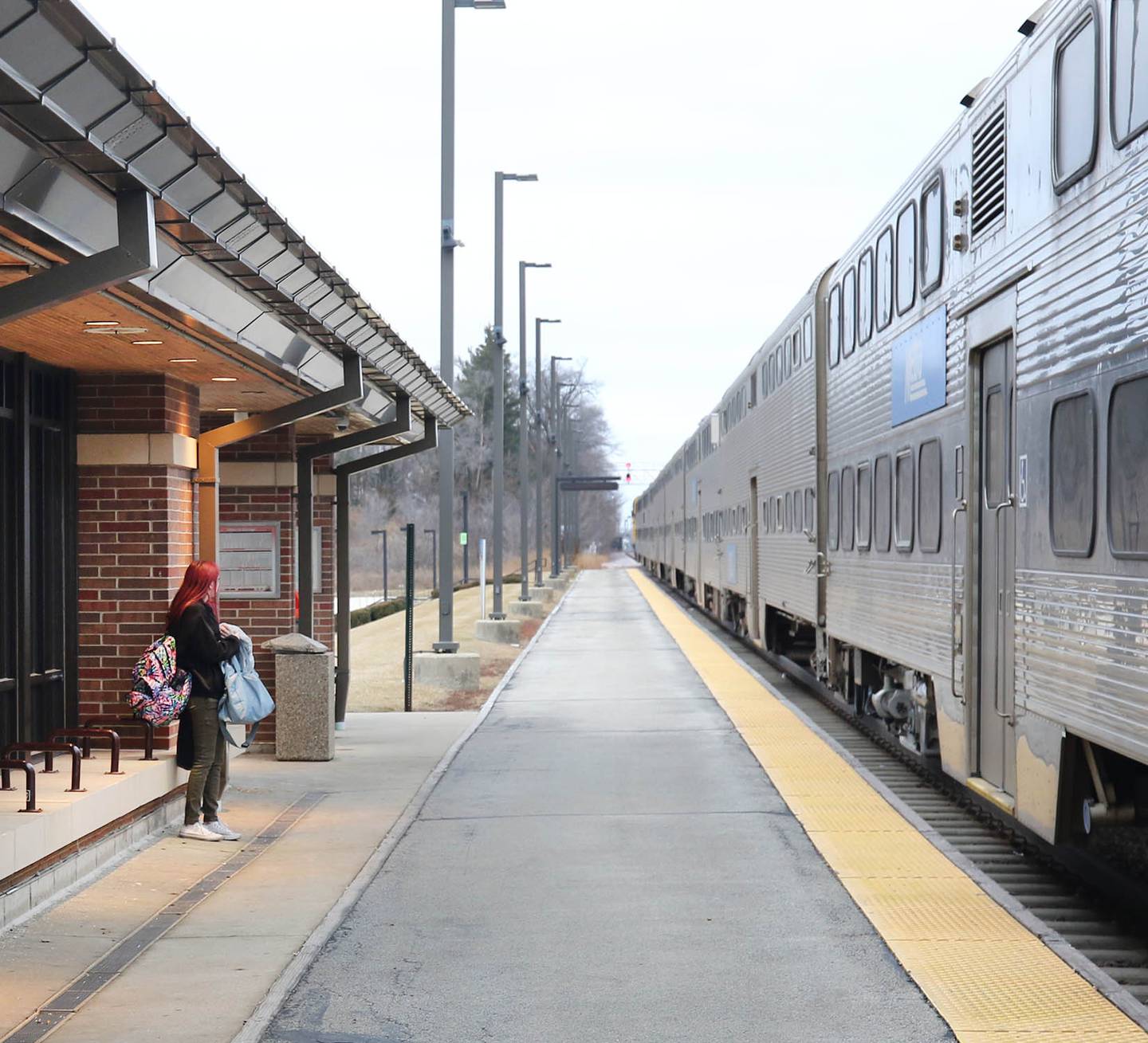 A commuter waits to board the train Thursday, Jan. 12, 2023, at the Elburn Metra Station.