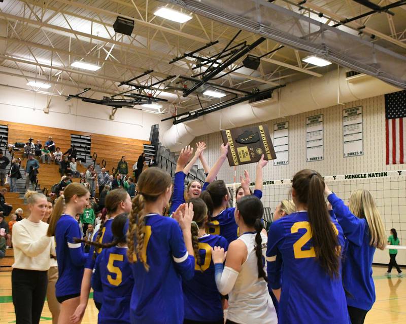 Lyons Township’s volleyball team celebrates with the regional title plaque after taking the win over York on Thursday Oct. 30, 2025, held at York High School.