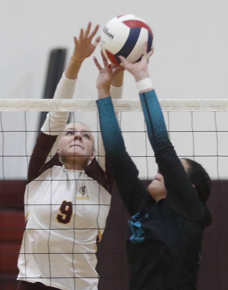 Richmond-Burton's Reagan Wisniewski tries to block the bal and Woodstock North's Gabriella Schefke sets the ball during a Kishwaukee River Conference volleyball match on Wednesday, Oct. 15, 2025, at the Richmond-Burton High School in Richmond.