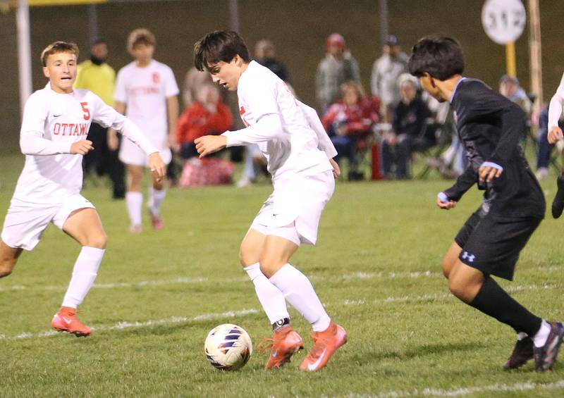 Ottawa's Luca Fernandez passes the ball to teammate Rory Moore as Kankakee's Luisangel Pereda defends during the Class 2A Regional semifinal game on Monday, Oct. 20, 2025 at Ottawa HIgh School.