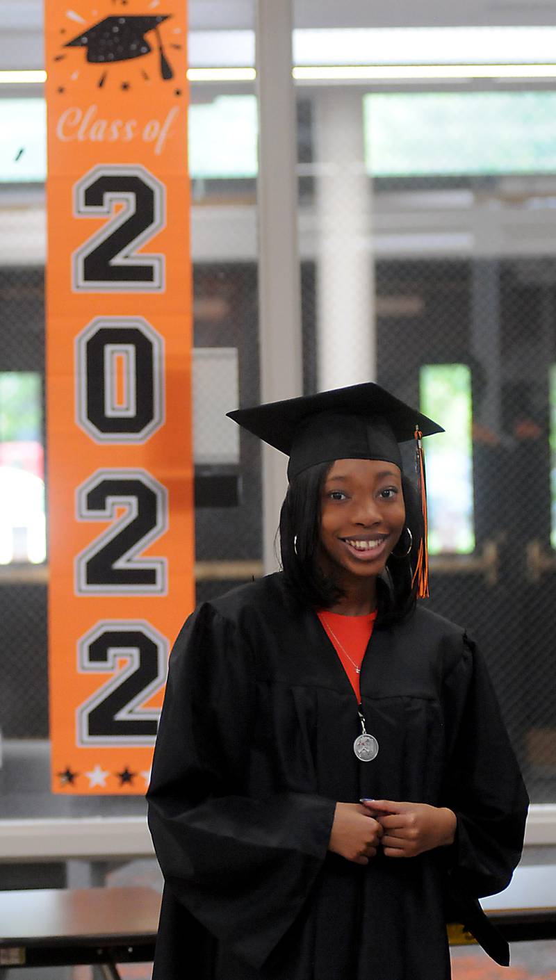 Amia Washington stands by a 2022 sign as she waits for the graduation ceremony to start Saturday, May 14, 2022, at Crystal Lake Central High School.