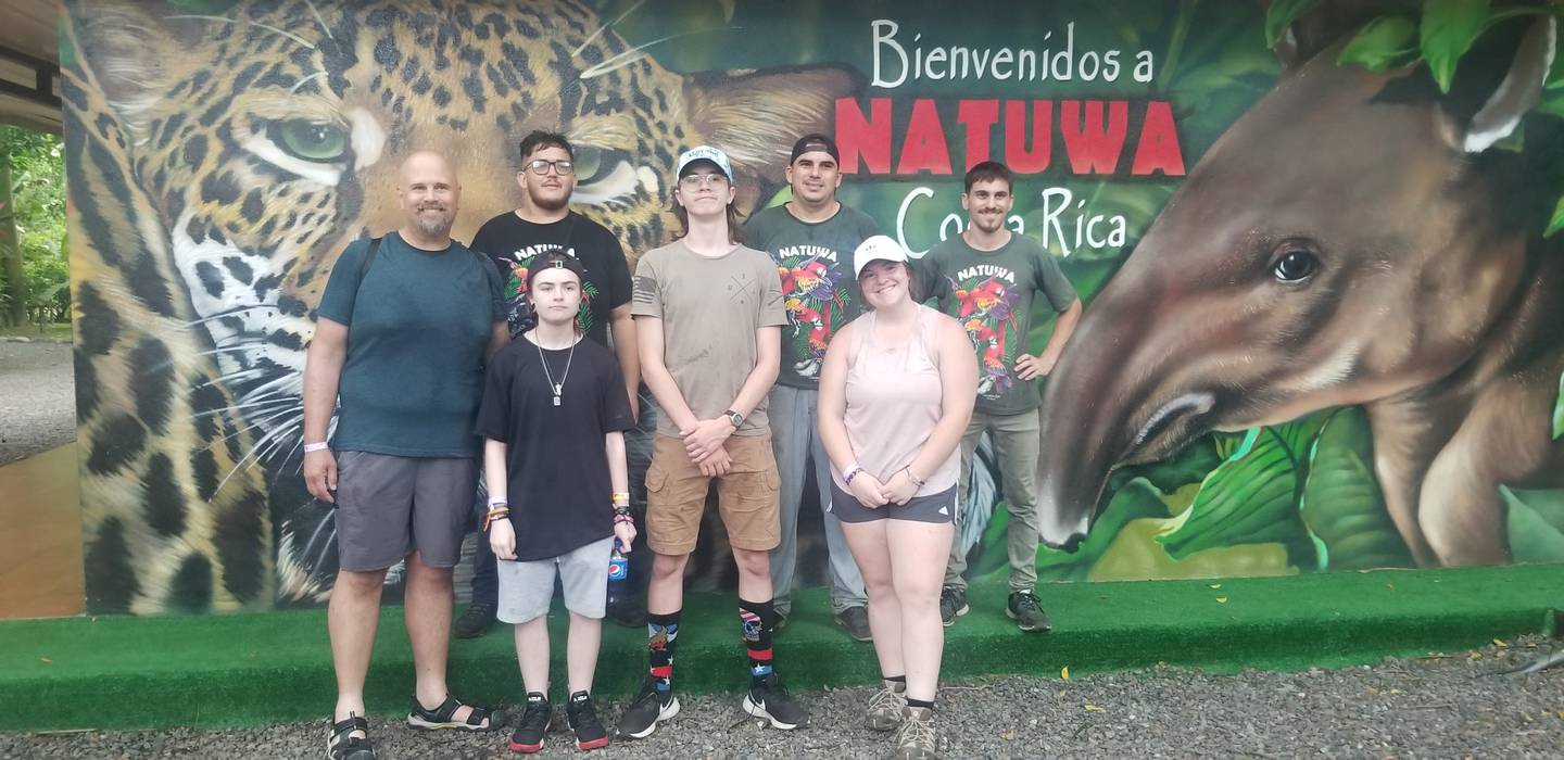 The group from Hall High School at the animal sanctuary after presenting a monetary donation (left to right) Robert Malerk, Lucas Gruber, Reid Sartain, Hope Whighstil, (back row) sanctuary workers.