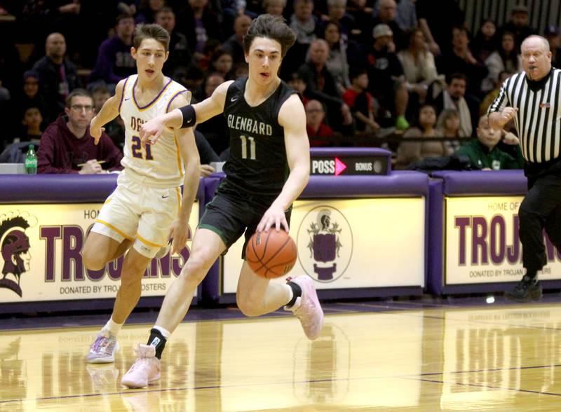 Glenbard West’s Logan Brown (right) goes after a loose ball  away from Downers Grove North’s Jack Stanton during a game at Downers Grove North on Friday, Jan. 13, 2023.