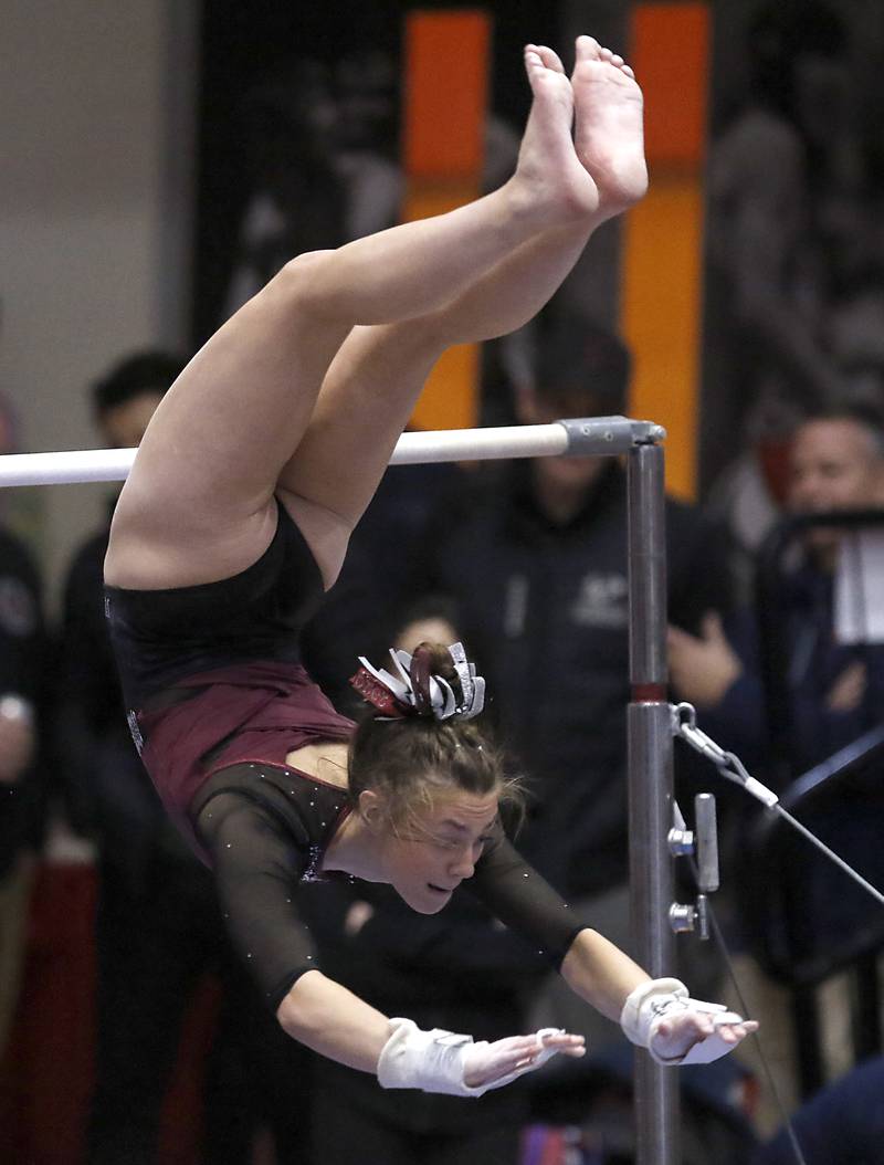 Prairie Ridge’s Gabby Riley competes in the of the uneven parallel bars Friday, Feb. 17, 2023, during the IHSA Girls State Final Gymnastics Meet at Palatine High School.