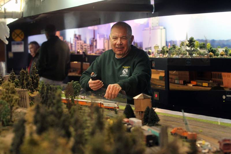 Frank Blacker, of Wauconda uses a controller to run his Milwaukee Road Hiawatha train while it runs on the tracks at the Lake County Model Railroad Club in Wauconda. The club is celebrating its 50th anniversary.