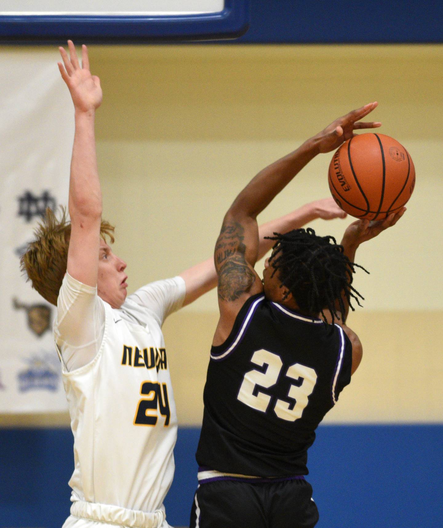 Neuqua Valley's James Coviello, left, defends a drive by Hampshire’s Adrien Ugochukwu during semifinals of the Wheeling Hardwood Classic basketball tournament Friday December 29, 2023 in Wheeling.