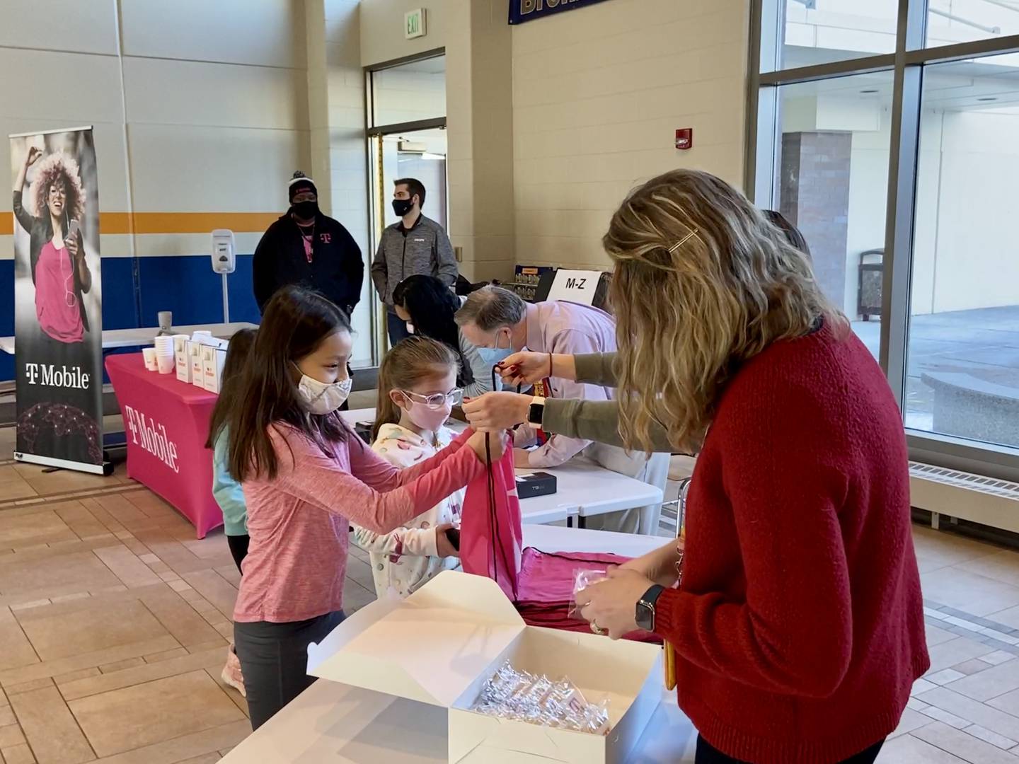 Woodstock School District students receive internet connectivity devices Tuesday, Feb. 8, 2022, as a part of T-Mobile's Project 10Million at  Prairiewood Elementary School in Woodstock.