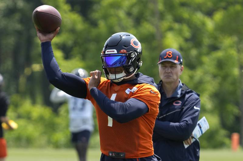 Chicago Bears quarterback Justin Fields works on the field as head coach Matt Eberflus looks on during practice, Wednesday, June 7, 2023, in Lake Forest.