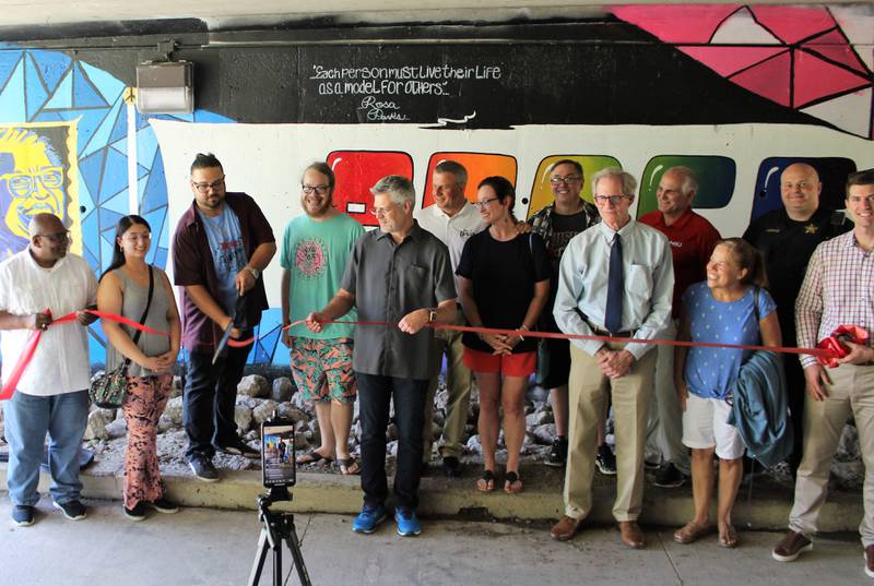 City of DeKalb and Citizens’ Community Enhancement Commission holding a ribbon cutting for the Unity Mural in the Lincoln Highway bike underpass last summer