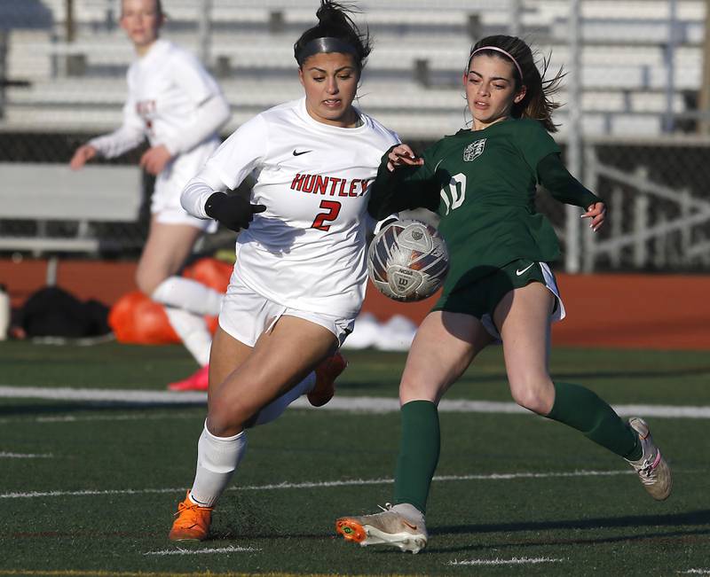 Huntley's Gabi Farraj battles with Boylan Catholic's Joscelyn Posada to share down the ball during a nonconference soccer game on Wednesday, March 27, 2024, at Huntley High School.