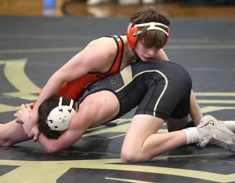DeKalb’s Matthew Frykman controls Sycamore’s Chase Cook during their 106 pound match Friday, Jan. 16, 2026, at Sycamore High School.