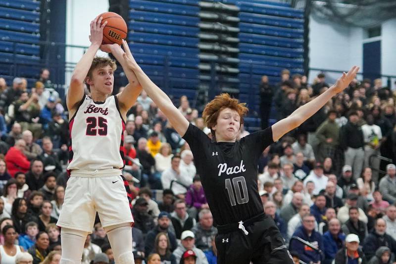 Benet’s Gabriel Sularski (25) shoots a three pointer over Oswego East's Noah Mason (10) during a Class 4A Oswego East regional final basketball game at Oswego East High School on Friday, Feb 23, 2024.