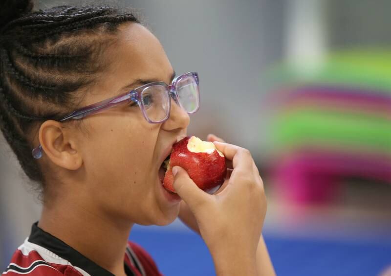 Teresa Johnson a student at Northwest Elementary School, bites into a apple during the Great Apple Crunch on Thursday, Oct,. 12, 2023 at Northwest School in La Salle. The Great Apple Crunch is an annual celebration of fresh, local apples on the second Thursday of October during National Farm to School Month. The apples were donated by Boggios Orchard and Produce.